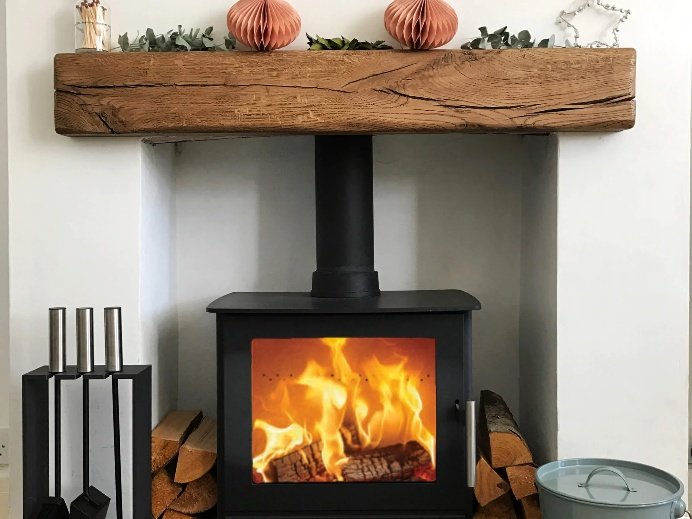Rustic oak beam above a wood burning stove