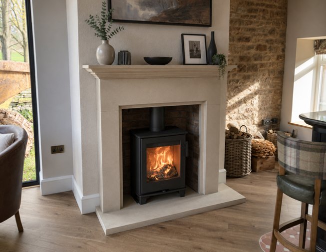 The Cranbrook natural sandstone fireplace with a rustic stone chamber and a Contura wood burning stove