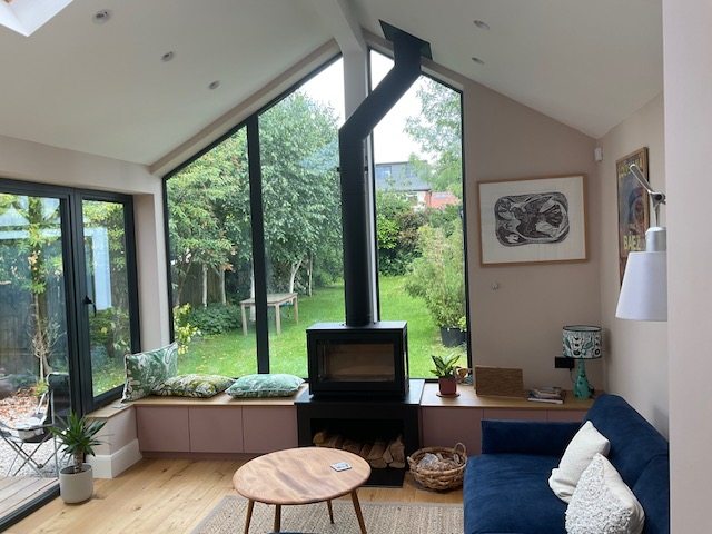 The three-sided stove and flue beneath the vaulted garden room ceiling