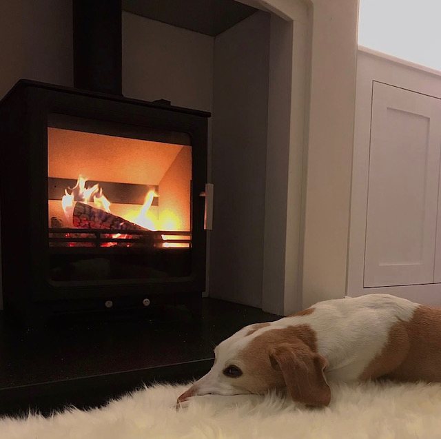 ACR Woodpecker 5 Plus multi-fuel stove with a limestone fireplace, fitted by Carl Finnell at Menston near Ilkley