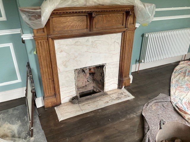 Before: the fireplace stripped out, with the old solid fuel backs removed.