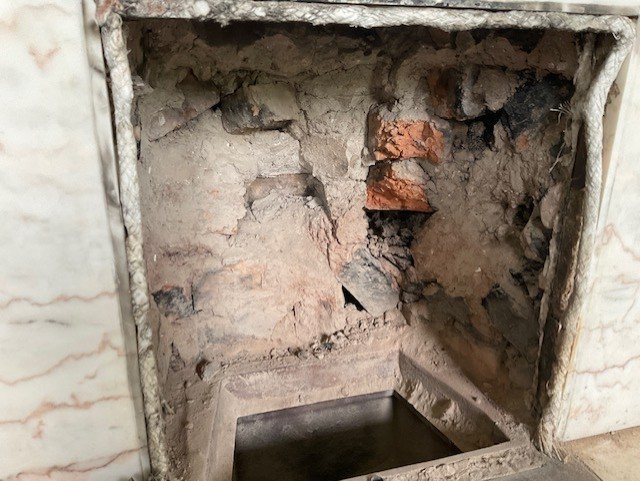 The opened chamber before the new clay back set went in.