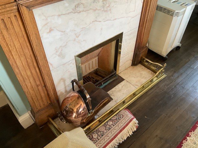 The same fireplace from the side, with the brass fender and hearth reinstated.