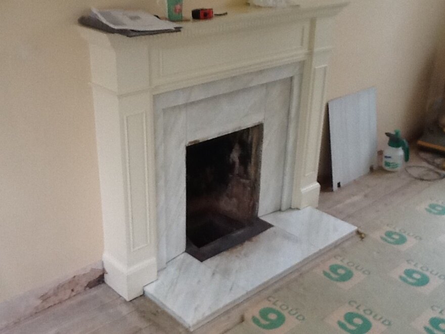 The Scarcroft fireplace before work, with an old open grate and marble insert