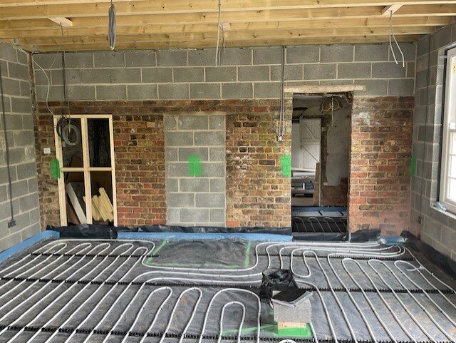 The underfloor heating left clear beneath the fireplace, ready for the granite hearth