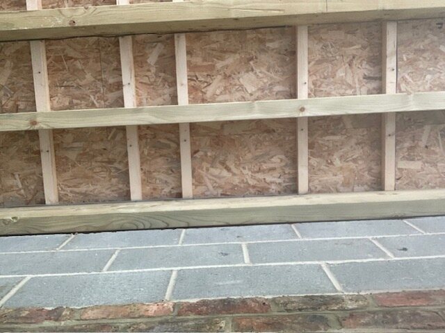 The roof timbers set out during the build to let the flue pass through cleanly