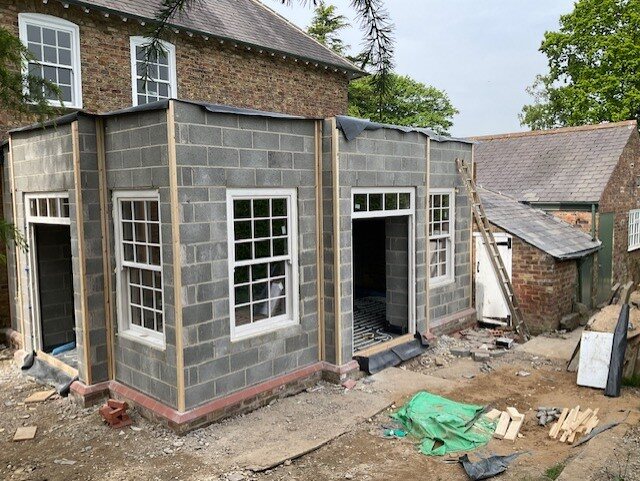 The new garden room under construction, with the fireplace position set out on the main external wall