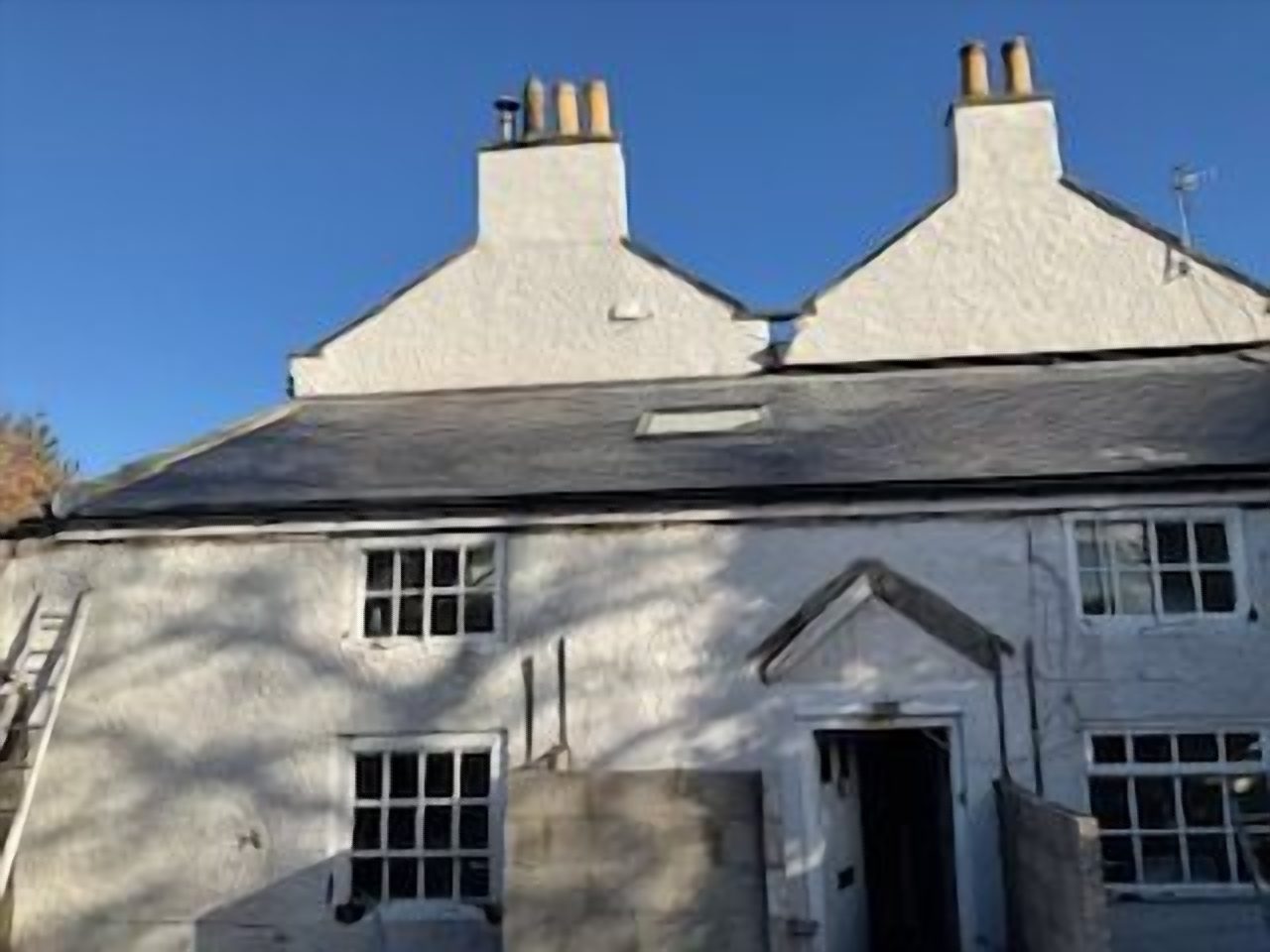 The chimney above, left elevation, capped with a ventilated cowl