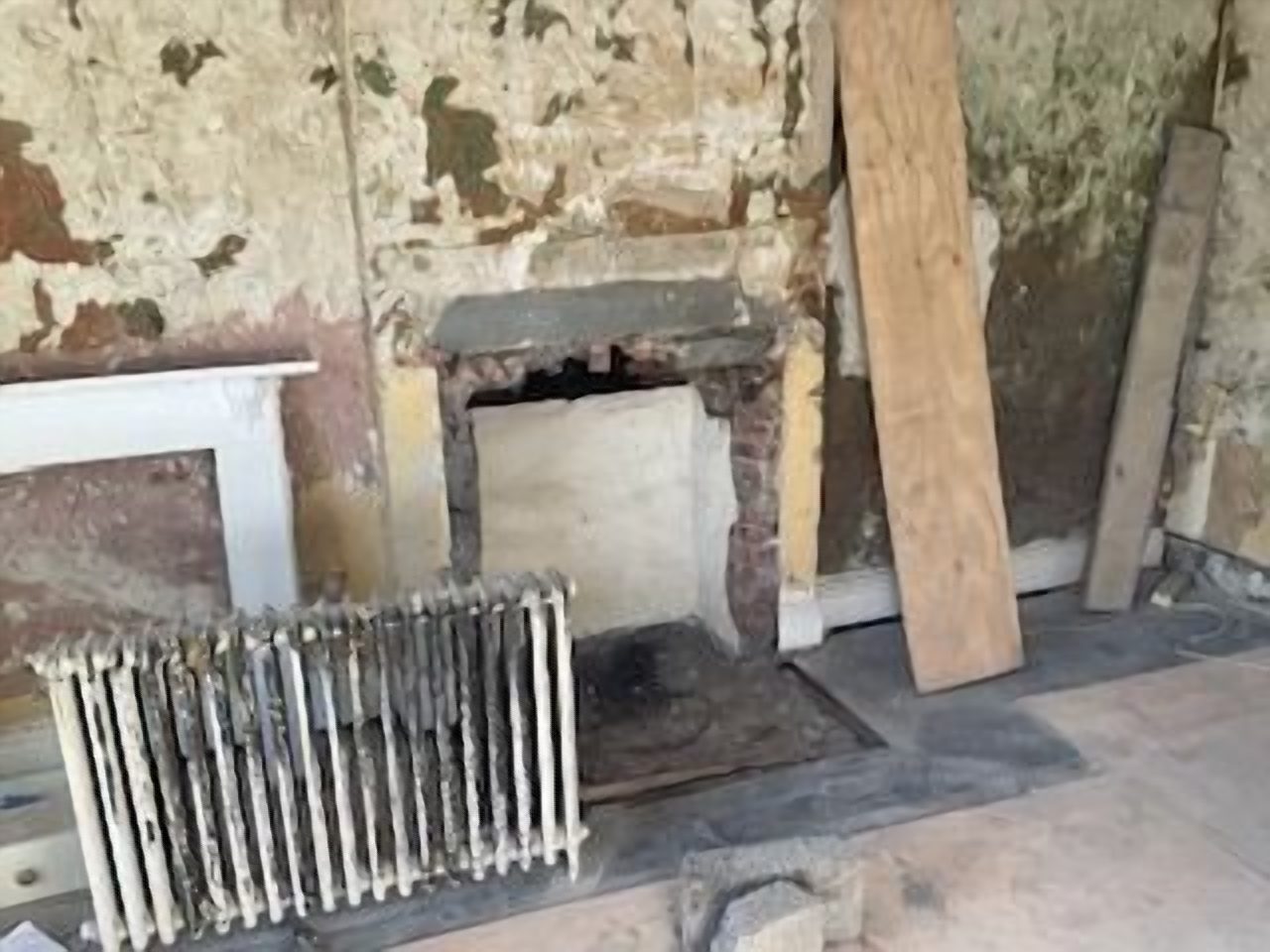 Before: the dining room chimney breast during the strip out