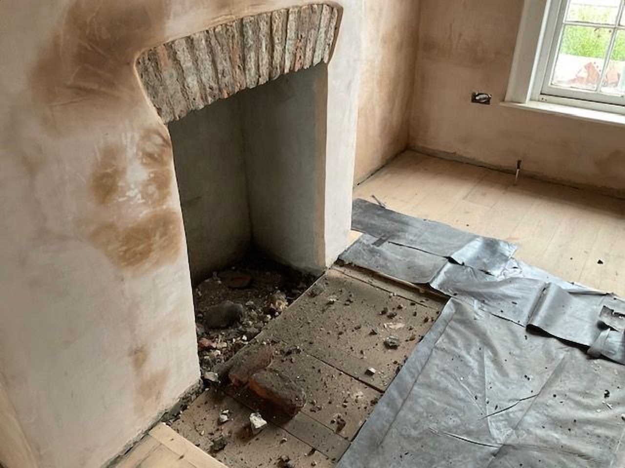 The chamber plastered and ready for its tiled hearth