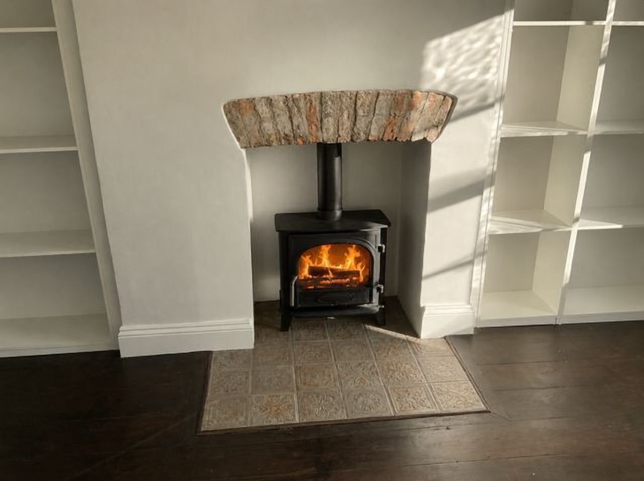After: the Stovax Stockton 5 on its tiled hearth in the restored brick chamber