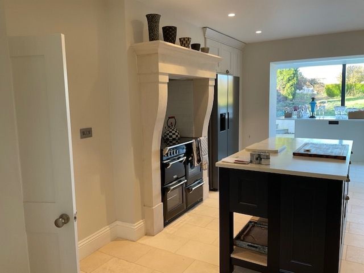 After: the made to measure limestone surround framing the range