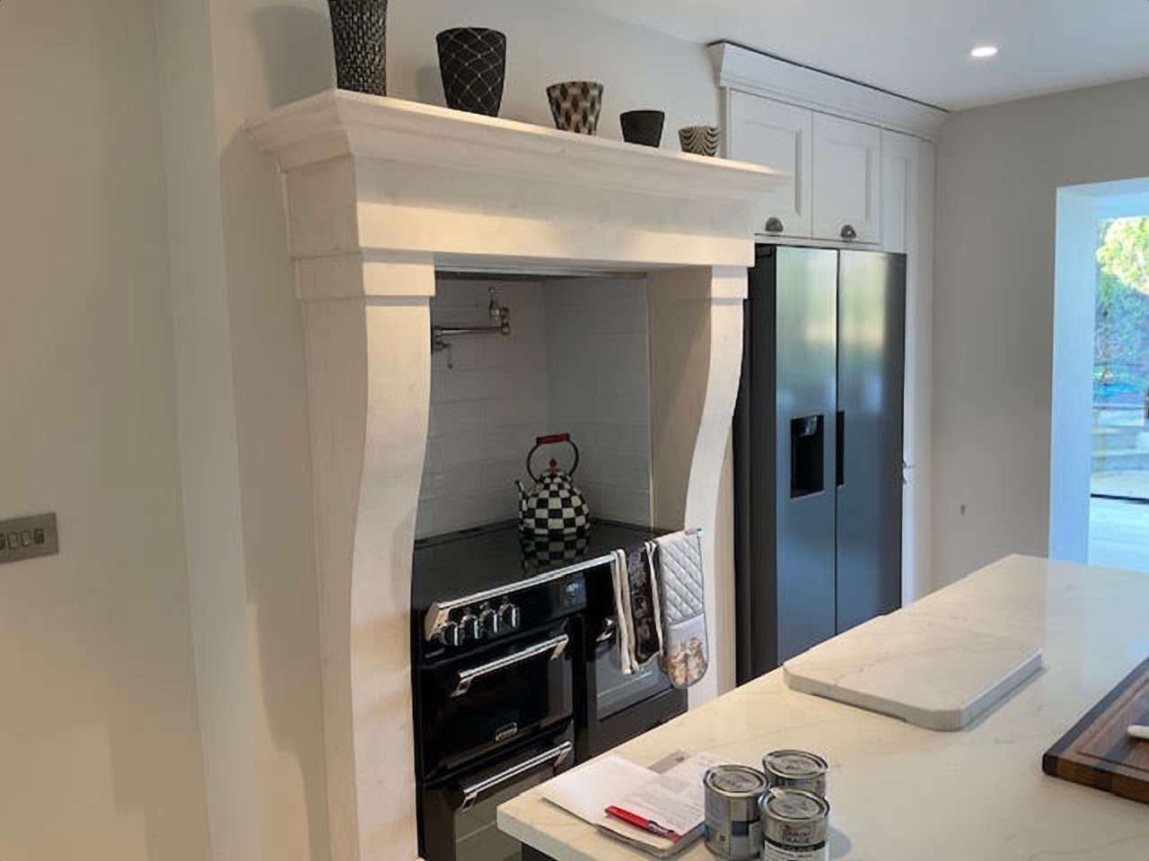 The kitchen: made to measure limestone surround framing the range