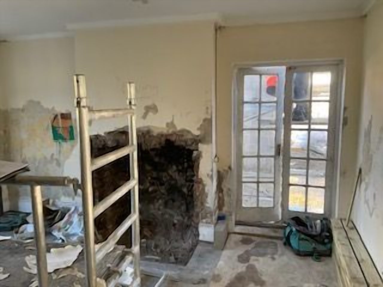 Before: the living room chimney breast stripped back during the restoration