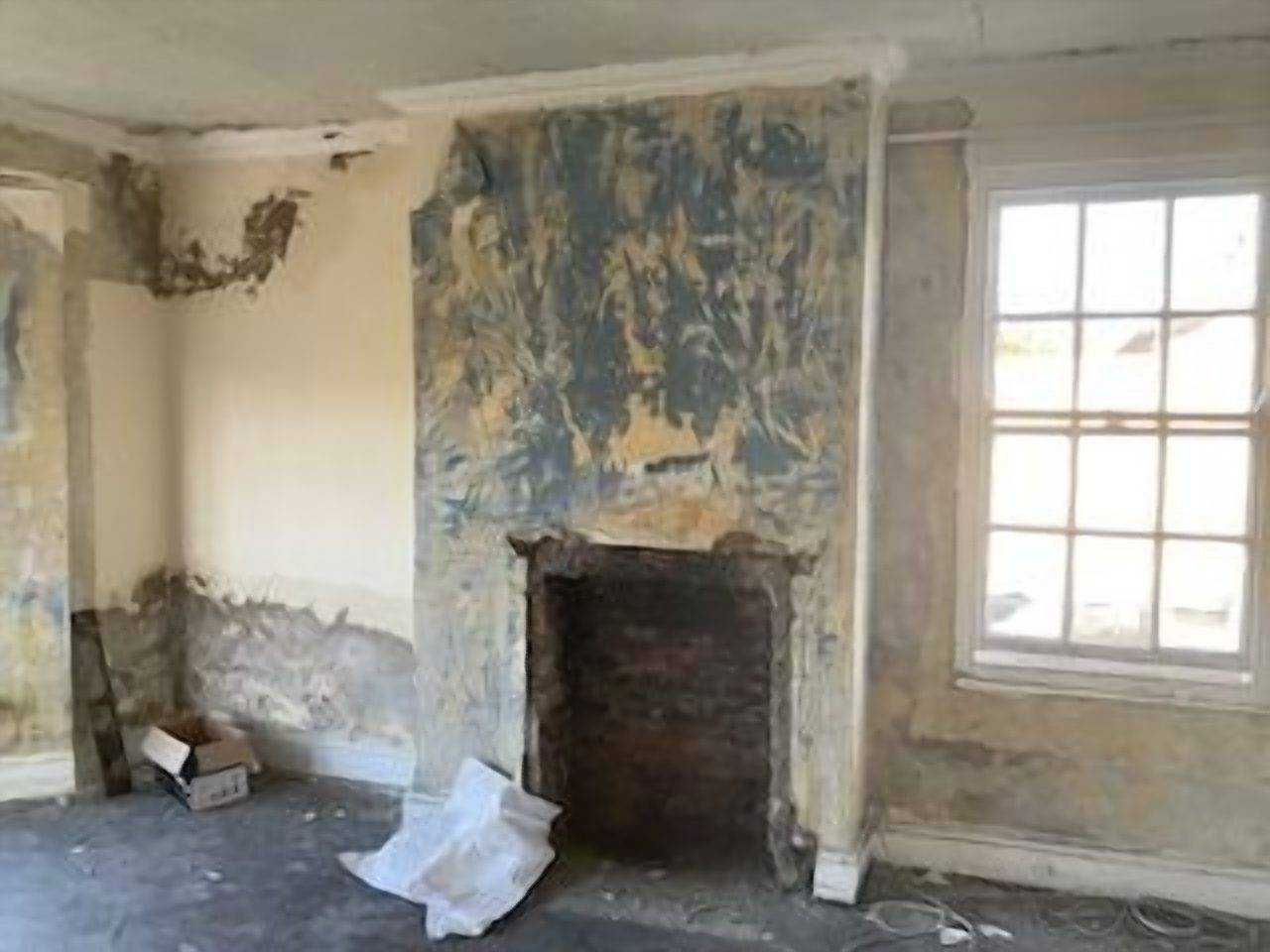 Before: the opening after the old timber surround was removed