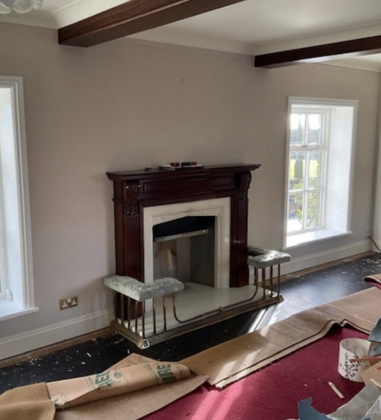 Before: the original open fireplace and mahogany surround, room mid-renovation