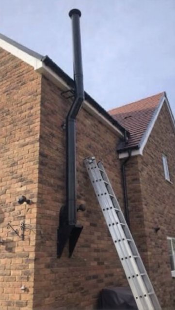 The external twin-wall flue routed neatly around the soffit and gutter