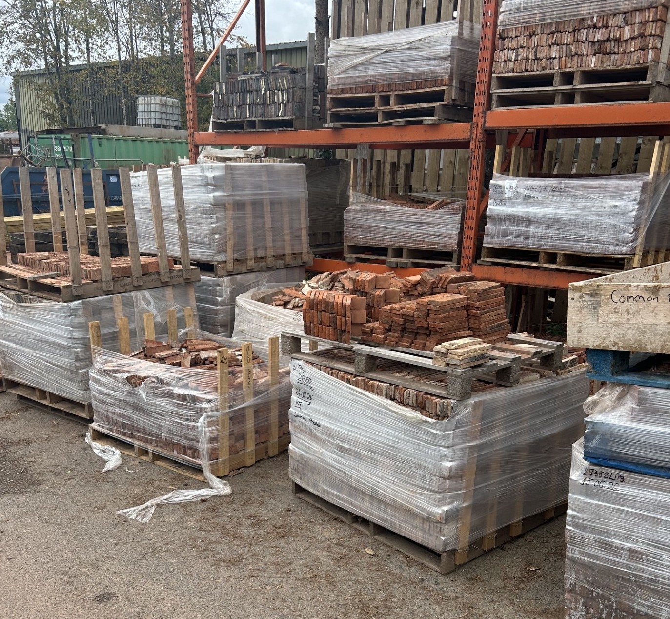 Pallets of reclaimed brick slips in different colours and textures in the yard