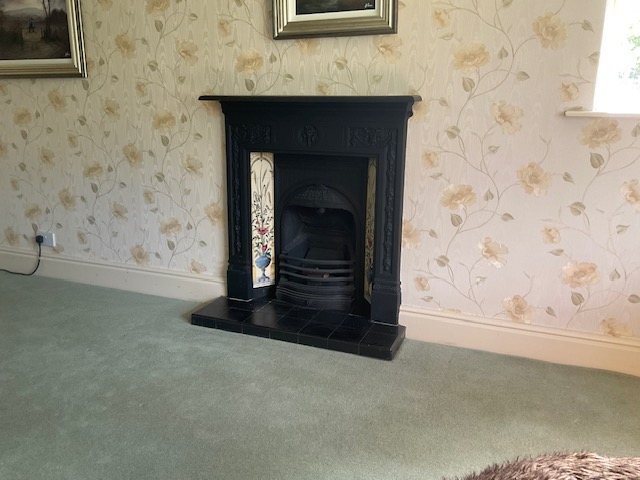 Before: the original cast iron open fire in the room, photographed at survey.