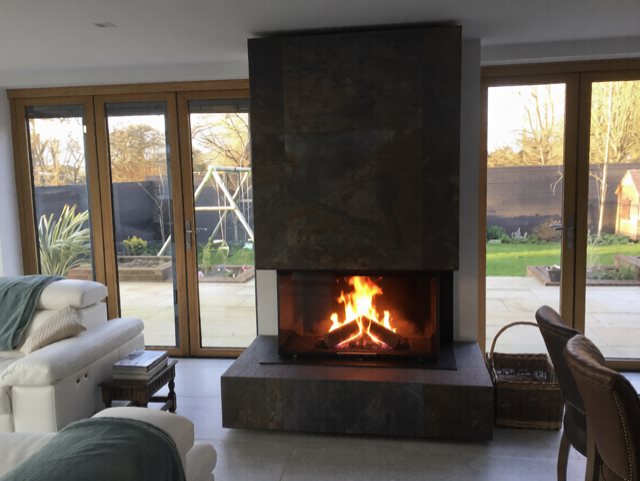 Spartherm Linear Triple feature fireplace with bespoke porcelain wall fitted by Carl Finnell in York
