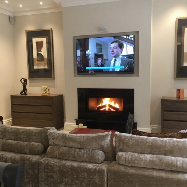 A Stovax Studio 2 cassette wood burning fire with a TV recessed above and a log store below in Wakefield
