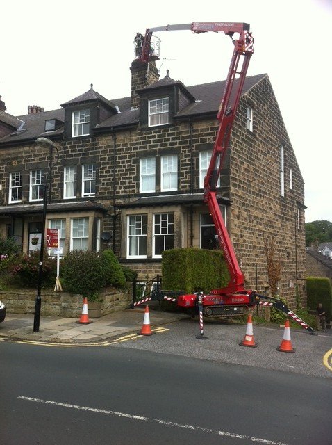 Tall Harrogate chimney reached by boom lift for a liner installation