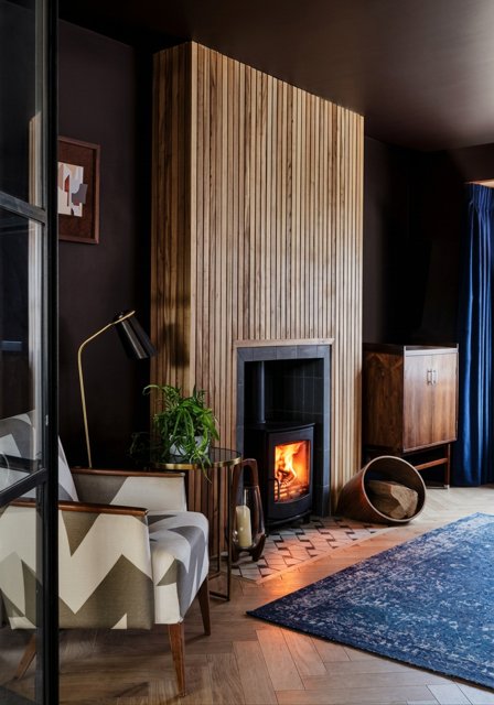A tiled hearth against a slate chamber