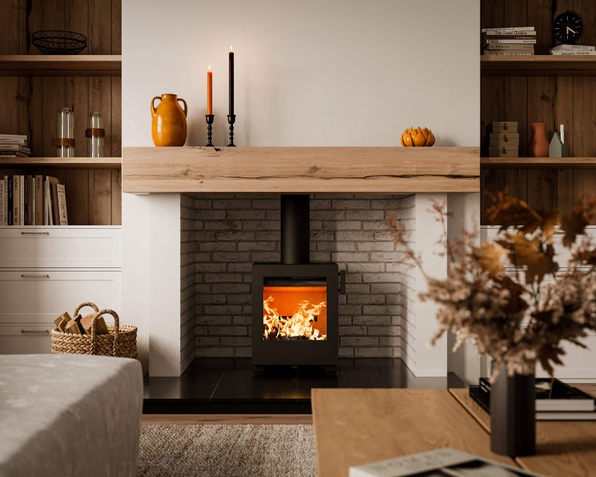 Heta Kube 10 wood burning stove in a brick fireplace chamber beneath an oak beam mantel